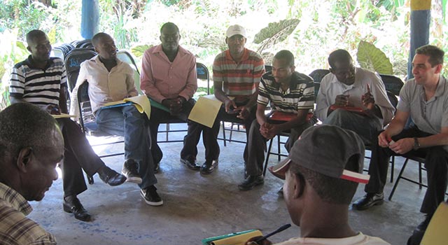 SIS professor Anthony Wanis conducts peace conversations in Haiti with several men